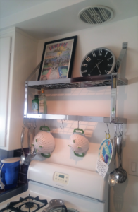 Stainless steel shelf above kitchen stove in Brentwood apartment